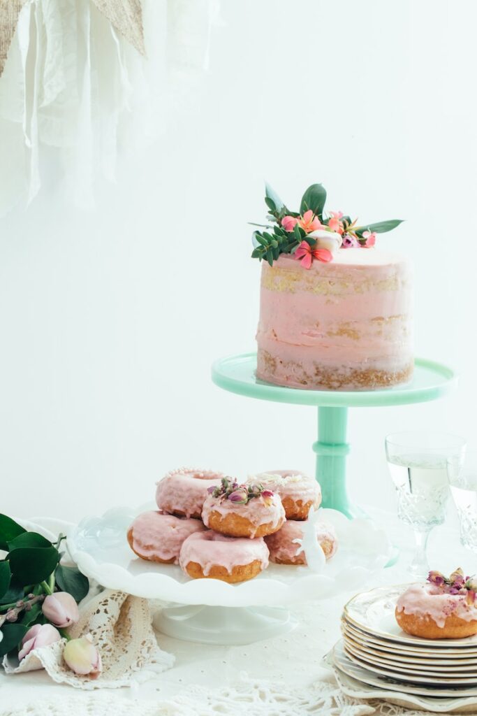 pink cake and donuts at a baby shower